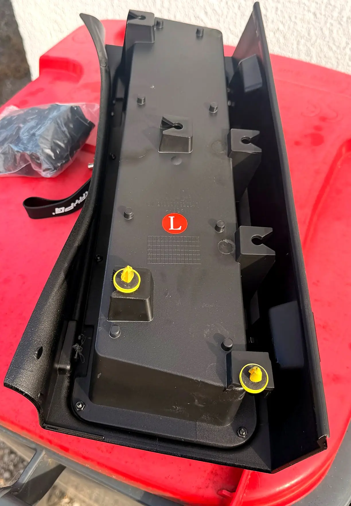 Back side of the new D-pillar storage box with mounting clips